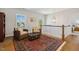 Upstairs hallway with a sitting area, featuring a decorative rug and overhead chandelier at 304 Channel Cove Dr, Holly Springs, NC 27540