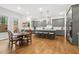 Spacious eat-in kitchen featuring gray cabinets, stainless appliances, and hardwood flooring at 304 Channel Cove Dr, Holly Springs, NC 27540
