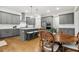 Modern kitchen with gray cabinets, an island with seating, and stainless steel appliances at 304 Channel Cove Dr, Holly Springs, NC 27540