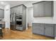 Modern kitchen with stainless steel appliances and gray cabinets with gold hardware at 304 Channel Cove Dr, Holly Springs, NC 27540