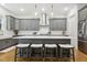Stylish kitchen island with pendant lighting, bar stool seating, and white subway tile backsplash at 304 Channel Cove Dr, Holly Springs, NC 27540
