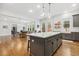 Bright, open kitchen featuring a center island, modern appliances, and a view to the living area at 304 Channel Cove Dr, Holly Springs, NC 27540