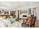 Spacious living room with hardwood floors, a cozy fireplace, and stylish decor at 304 Channel Cove Dr, Holly Springs, NC 27540
