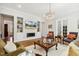 Well-lit living room with chandelier, fireplace, and views to the outside at 304 Channel Cove Dr, Holly Springs, NC 27540