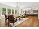 Bright living room with hardwood floors, a large window, and an open floor plan at 304 Channel Cove Dr, Holly Springs, NC 27540