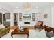 Elegant living room featuring a chandelier, built-in shelves, and a fireplace at 304 Channel Cove Dr, Holly Springs, NC 27540