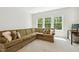 The room features a large sectional couch and bright windows with lots of light at 304 Channel Cove Dr, Holly Springs, NC 27540