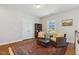 Upstairs sitting area with a decorative rug, bookshelf, two chairs, and a bright window at 304 Channel Cove Dr, Holly Springs, NC 27540
