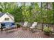 An expansive back deck surrounded by lush trees; outdoor seating for relaxation and entertainment at 308 Hassellwood Dr, Cary, NC 27518