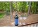 Wine and glasses sit on a deck railing in front of a backdrop of lush green trees at 308 Hassellwood Dr, Cary, NC 27518