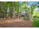 Back exterior showing a house in a forest setting with a backyard and deck at 308 Hassellwood Dr, Cary, NC 27518