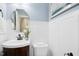 Powder room featuring a vanity sink, dark wood cabinetry, and decorative mirror at 308 Hassellwood Dr, Cary, NC 27518