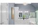 Bright bathroom featuring a double vanity, decorative lighting, and glass shower enclosure at 308 Hassellwood Dr, Cary, NC 27518