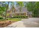 Beautiful brick two-story home featuring manicured landscaping, dormers, and attached garage at 308 Hassellwood Dr, Cary, NC 27518