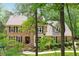 Brick two-story home with dormers, a manicured lawn, and mature trees offering curb appeal at 308 Hassellwood Dr, Cary, NC 27518