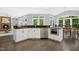 Open concept kitchen with white cabinets, stainless steel appliances, dark counter tops, and wood floors at 308 Hassellwood Dr, Cary, NC 27518