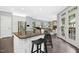 Open kitchen and living room with hardwood floors, granite countertops, stainless steel appliances, and a breakfast bar at 308 Hassellwood Dr, Cary, NC 27518
