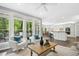 Bright living room with large windows and view to the open concept kitchen and dining area at 308 Hassellwood Dr, Cary, NC 27518