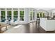 Living Room with hardwood floors, white walls, a white sofa, and a view into a kitchen with a breakfast bar at 308 Hassellwood Dr, Cary, NC 27518