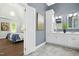 View of a main bedroom and main bathroom with double sinks, and vanity, white cabinetry and a walk in shower at 308 Hassellwood Dr, Cary, NC 27518