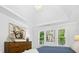 Spacious main bedroom featuring hardwood floors, neutral decor, and natural light from two large windows at 308 Hassellwood Dr, Cary, NC 27518