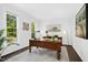 Home office features a large wooden desk, neutral rug, and natural light from two windows at 308 Hassellwood Dr, Cary, NC 27518