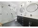 Modern bathroom with dual sinks, sleek black vanities, a glass-enclosed shower, and contemporary fixtures at 310 Georgetown Rd, Raleigh, NC 27608