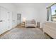 Bright Bedroom features modern crib, dresser, patterned rug, and access to open landing at 310 Georgetown Rd, Raleigh, NC 27608