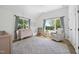 Bright Bedroom featuring two windows, vaulted ceilings, and a patterned area rug at 310 Georgetown Rd, Raleigh, NC 27608