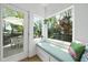 Cozy breakfast nook with a cushioned bench, windows offering natural light, and backyard access at 310 Georgetown Rd, Raleigh, NC 27608