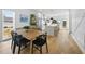 Dining area with open layout to the kitchen featuring modern appliances and an island with bar seating at 310 Georgetown Rd, Raleigh, NC 27608