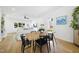 Bright dining area with a wooden table, modern black chairs, and hardwood floors at 310 Georgetown Rd, Raleigh, NC 27608