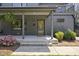 Inviting front porch with dark gray painted brick, a stylish front door, and lush landscaping at 310 Georgetown Rd, Raleigh, NC 27608