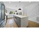 Modern kitchen featuring a large island with pendant lighting, stainless steel appliances, and ample counter space at 310 Georgetown Rd, Raleigh, NC 27608