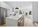 Bright, open kitchen featuring a large island with bar seating, white cabinetry, and hardwood floors at 310 Georgetown Rd, Raleigh, NC 27608