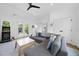 Bright living room features a sectional sofa, a Golden Tee arcade game, and access to an outdoor deck at 310 Georgetown Rd, Raleigh, NC 27608