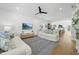 Spacious living room with hardwood floors, white sofas, and open layout to the kitchen at 310 Georgetown Rd, Raleigh, NC 27608