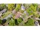 Aerial view of a brick home with beautiful landscaping, a fenced backyard, and mature trees at 3126 Truitt Dr, Burlington, NC 27215