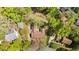 Aerial view of a brick home with a fenced backyard, beautiful landscaping, and mature trees at 3126 Truitt Dr, Burlington, NC 27215