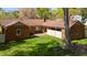 Brick home featuring a patio, privacy fence, and a serene, well-manicured backyard with mature trees at 3126 Truitt Dr, Burlington, NC 27215
