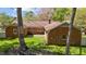 Brick home exterior with a cozy patio, well-maintained yard, and mature trees at 3126 Truitt Dr, Burlington, NC 27215
