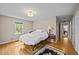 This bedroom has hardwood floors, and a large window that provides natural light at 3126 Truitt Dr, Burlington, NC 27215
