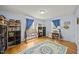Bright bedroom featuring hardwood floors, and shelves with cubbies beside a small drafting table at 3126 Truitt Dr, Burlington, NC 27215