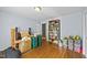 Bedroom showcases hardwood floors, a large bookcase, storage containers and bright natural light at 3126 Truitt Dr, Burlington, NC 27215