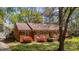 Quaint one-story brick home featuring blooming bushes, mature landscaping, and a cozy feel at 3126 Truitt Dr, Burlington, NC 27215