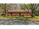 All brick, one-story home with mature trees and flowering bushes in a peaceful neighborhood setting at 3126 Truitt Dr, Burlington, NC 27215