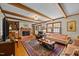 Spacious living room with hardwood floors, wood beams, fireplace, and traditional furnishings at 3126 Truitt Dr, Burlington, NC 27215