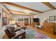 Inviting living room featuring exposed beams, hardwood flooring, and an oriental rug at 3126 Truitt Dr, Burlington, NC 27215