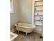 Classic bathroom with clawfoot tub, vintage sink, and built-in shelving at 330 W King St, Hillsborough, NC 27278