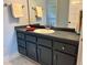 Bathroom vanity with drawers, cabinets, and a large mirror at 330 W King St, Hillsborough, NC 27278